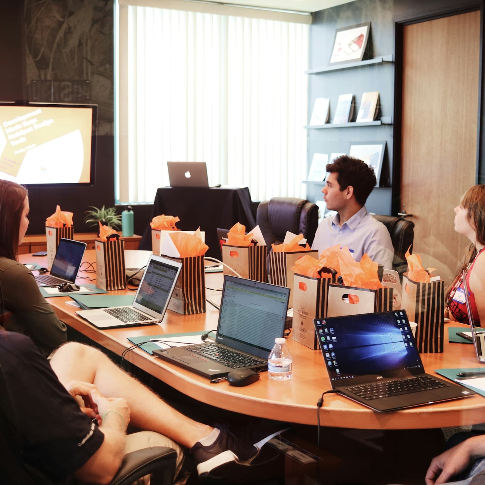 A discovery workshop around a conference table.