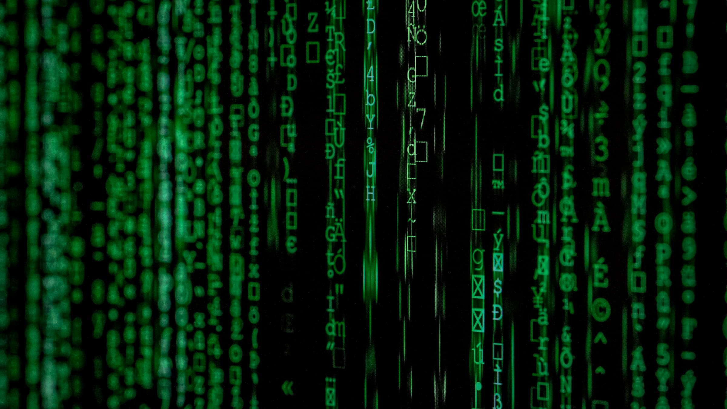 Streams of encrypted code cascading down a dark screen.