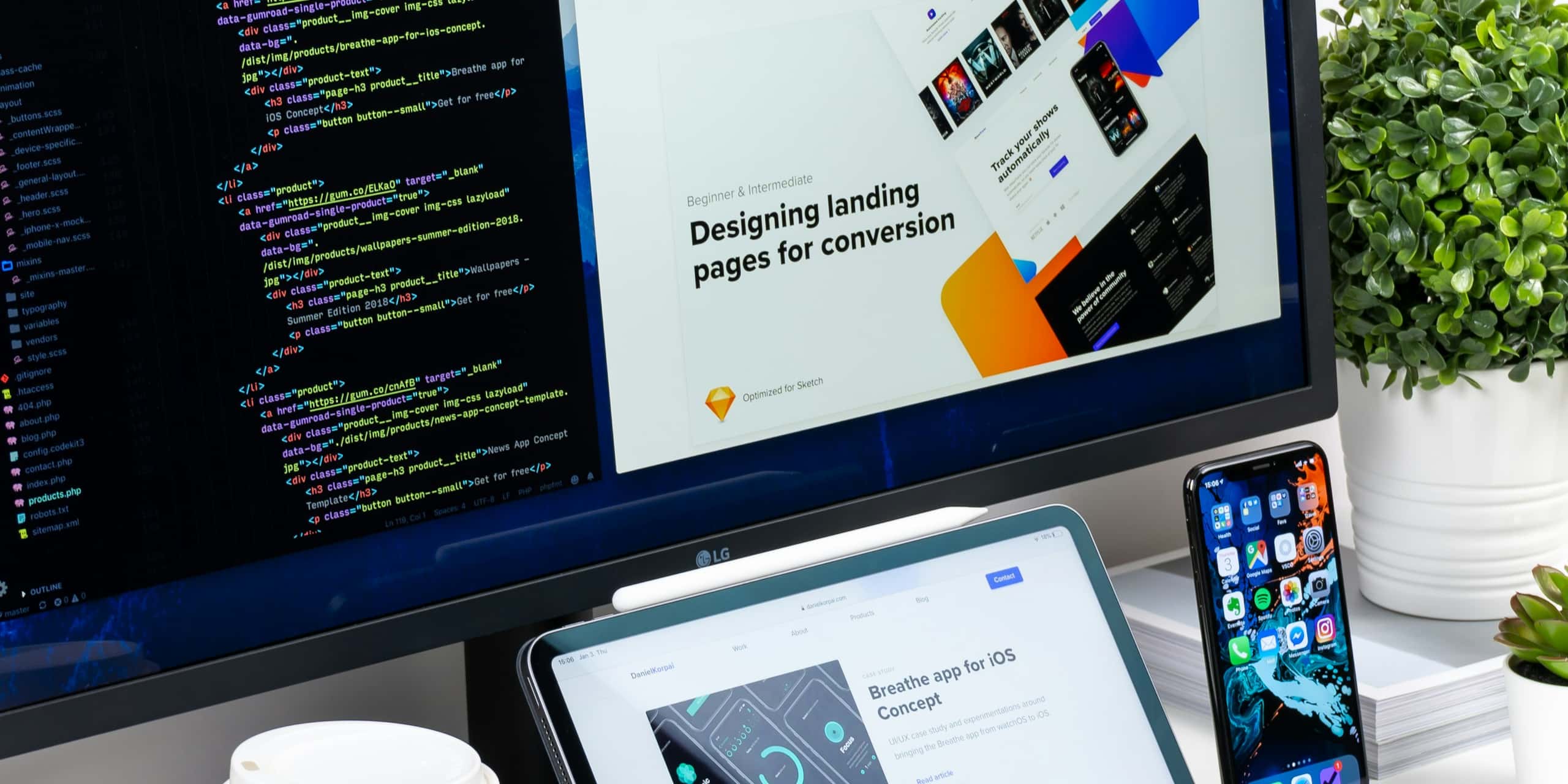 A developer workspace with code and designs across dual monitors.